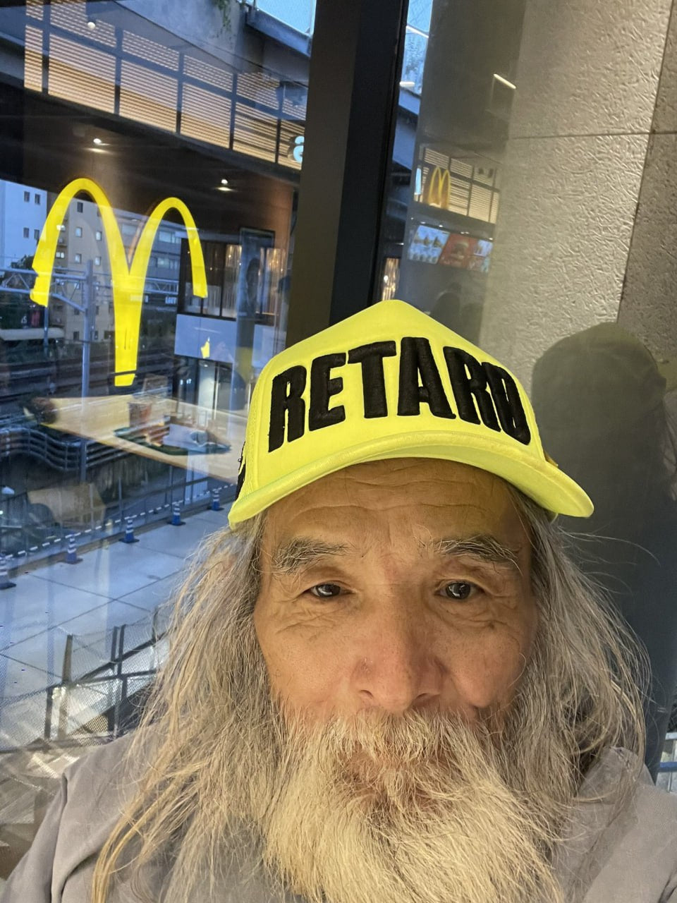 Fujimoto model wearing Yellow Retard Cap